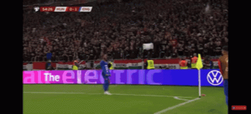 A Soccer Player Stands In Front Of A Sign That Says " All The Electric " GIF