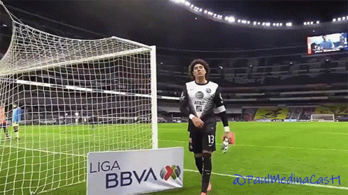 A Soccer Player Stands In Front Of A Sign That Says Liga Bbva GIF