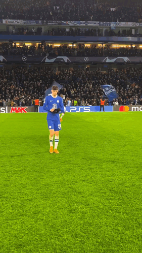 A Soccer Player Stands On A Field With A Ps5 Logo In The Background GIF