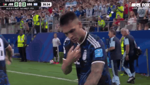 A Soccer Player Stands On The Field In Front Of A Crowd During A Match GIF