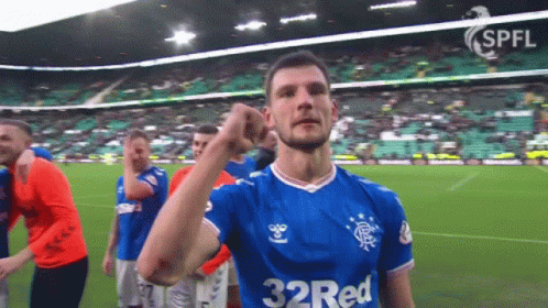 A Soccer Player Wearing A 32 Red Jersey Holds Up His Fist GIF