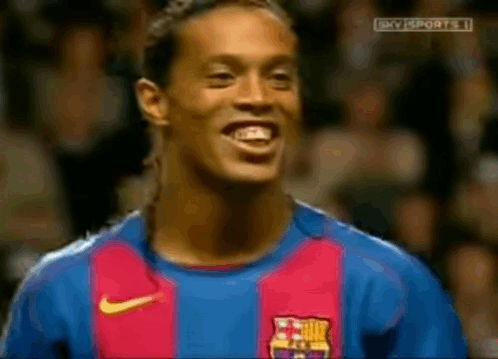 A Soccer Player Wearing A Barcelona Jersey Is Smiling GIF