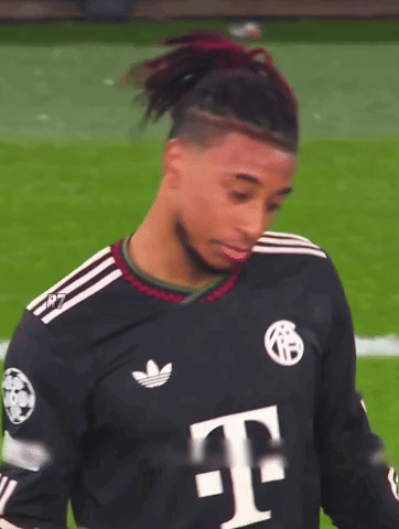 A Soccer Player Wearing A Black Adidas Jersey With A White T On It GIF