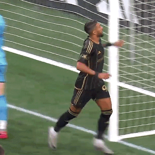 A Soccer Player Wearing A Black And Gold Jersey With The Word Adidas On It GIF
