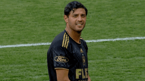 A Soccer Player Wearing A Black And Gold Jersey With The Word Flex On It GIF