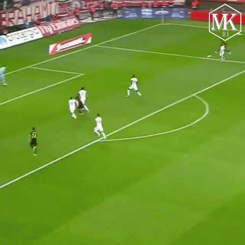 A Soccer Player Wearing A Black And Yellow Jersey Is Running On The Field GIF