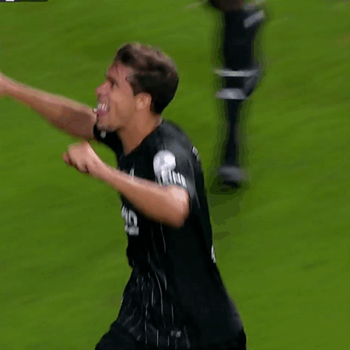 a soccer player wearing a black jersey that says long