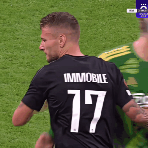 A Soccer Player Wearing A Black Jersey With The Number 17 On The Back GIF