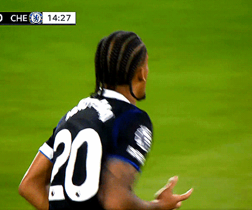 A Soccer Player Wearing A Black Jersey With The Number 20 On The Back GIF