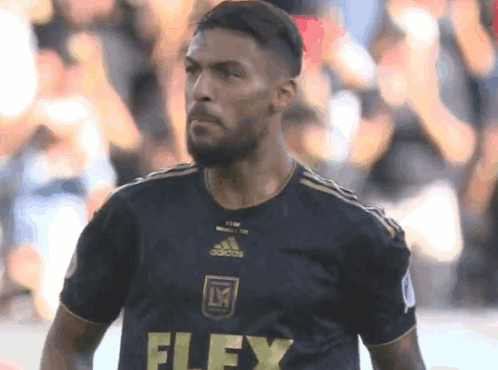 A Soccer Player Wearing A Black Jersey With The Word Flex On The Front GIF