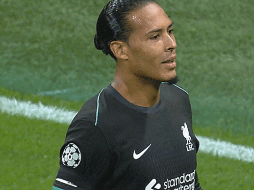A Soccer Player Wearing A Black Jersey With The Word Standard On It GIF
