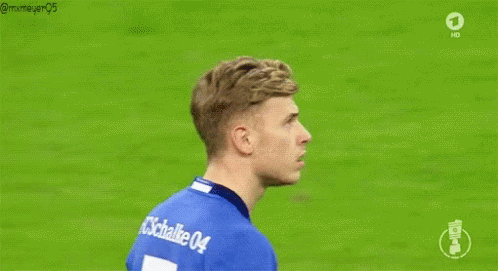 A Soccer Player Wearing A Blue Adidas Shirt Is Standing On A Soccer Field . GIF