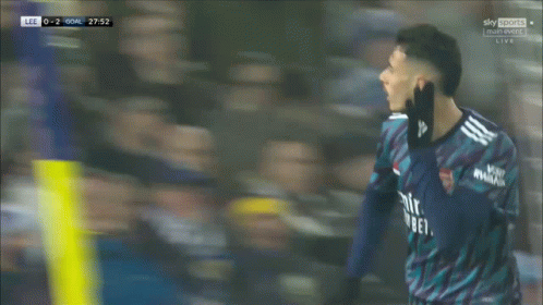 a soccer player wearing a blue jersey that says emirates better