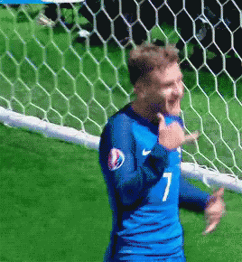 A Soccer Player Wearing A Blue Jersey With The Number 7 GIF