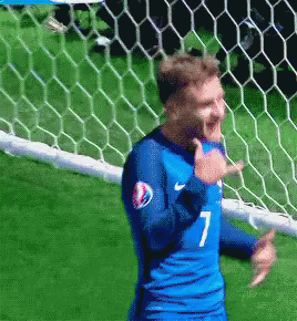 A Soccer Player Wearing A Blue Jersey With The Number 7 GIF