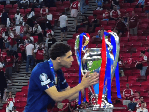 a soccer player wearing a blue shirt with the number 6 on it