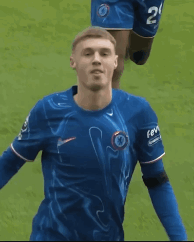 A Soccer Player Wearing A Blue Shirt With The Word Fev On The Sleeve GIF
