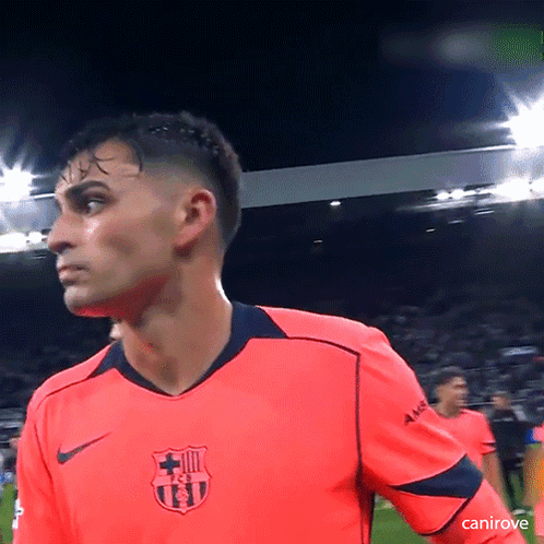 a soccer player wearing a bright pink shirt with a fcb logo on it
