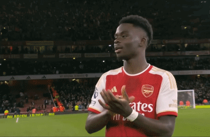 A Soccer Player Wearing A Fly Emirates Jersey Is Clapping GIF