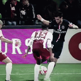 A Soccer Player Wearing A Fly Emirates Jersey Kicks The Ball GIF