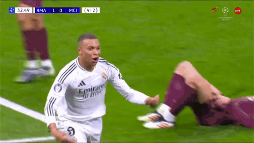 a soccer player wearing a fly emirates jersey runs on the field