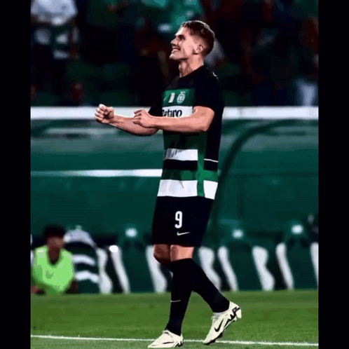 A Soccer Player Wearing A Green And White Jersey With The Number 9 On It GIF