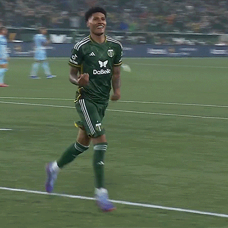 A Soccer Player Wearing A Green And Yellow Jersey With The Letter T On It GIF