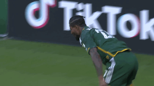 A Soccer Player Wearing A Green Jersey With The Number 11 On It GIF