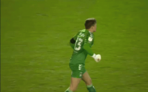 A Soccer Player Wearing A Green Jersey With The Number 13 On It Is Standing On The Field . GIF