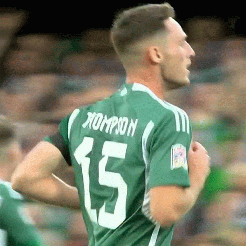 A Soccer Player Wearing A Green Jersey With The Number 15 On The Back GIF