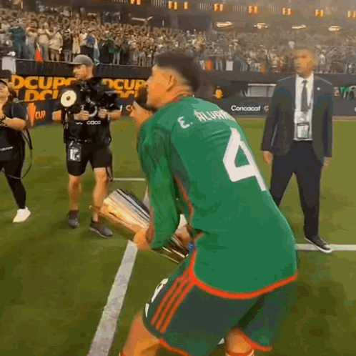 A Soccer Player Wearing A Green Jersey With The Number 4 On The Back GIF