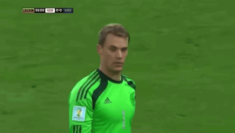 a soccer player wearing a green jersey with the word adidas on it