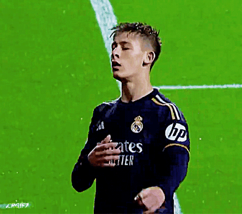 A Soccer Player Wearing A Jersey That Says Emirates Fly Better Holds His Hand To His Chest GIF