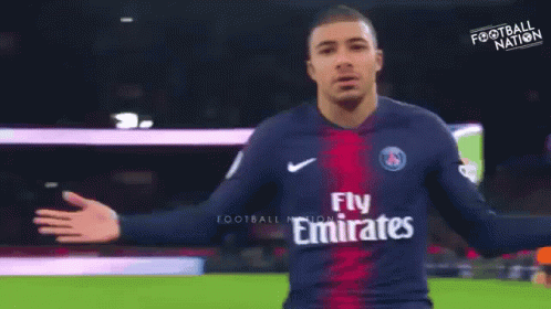 A Soccer Player Wearing A Jersey That Says Fly Emirates On It GIF
