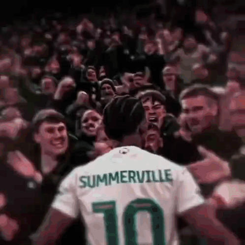 A Soccer Player Wearing A Jersey With The Number 10 On It Is Surrounded By Fans . GIF