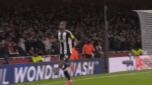 A Soccer Player Wearing A Jersey With The Number 14 Is Running On The Field GIF