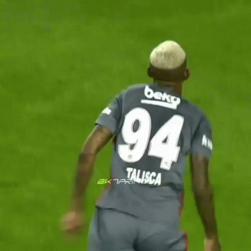 A Soccer Player Wearing A Jersey With The Number 94 On The Back GIF