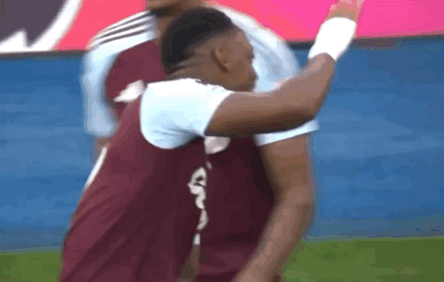 A Soccer Player Wearing A Maroon Jersey With A White Letter G On The Back GIF