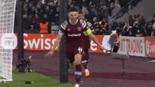A Soccer Player Wearing A Maroon Jersey With The Number 41 On It Celebrates A Goal GIF