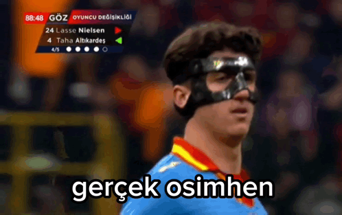 A Soccer Player Wearing A Mask With The Words Gerçek Osimhen Written Below Him GIF