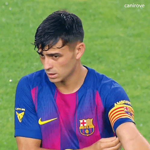 a soccer player wearing a nike jersey with a captain armband on his arm