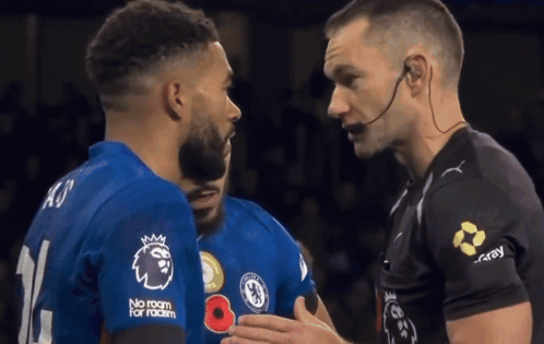 A Soccer Player Wearing A No Room For Racism Shirt Is Talking To Another Player GIF