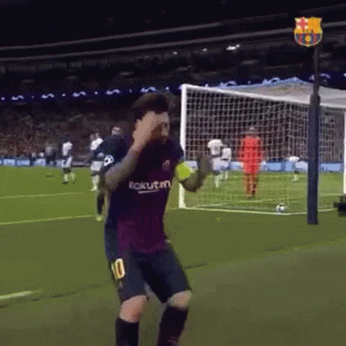 A Soccer Player Wearing A Number 10 Jersey Is Dancing On The Field . GIF