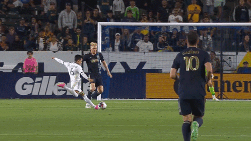 A Soccer Player Wearing A Number 10 Jersey Is Kicking The Ball GIF