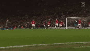 a soccer player wearing a number 10 jersey kicks the ball