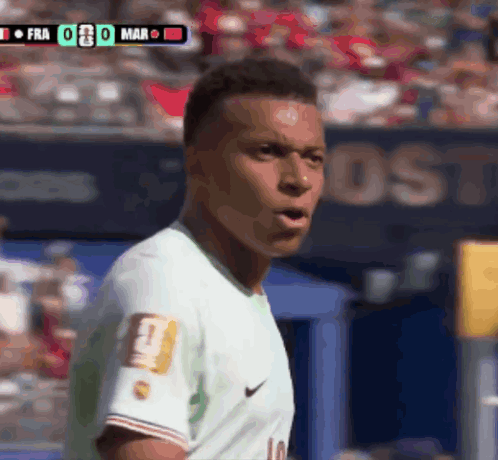 A Soccer Player Wearing A Number 10 Jersey Stands In Front Of A Scoreboard GIF