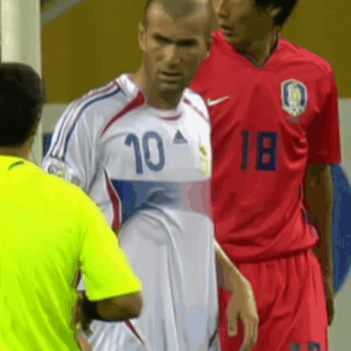 A Soccer Player Wearing A Number 10 Jersey Stands Next To Another Player Wearing A Number 18 Jersey GIF