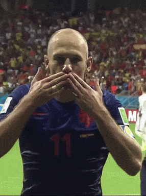 a soccer player wearing a number 11 jersey covers his mouth with his hands