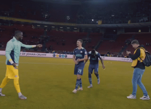 A Soccer Player Wearing A Number 28 Jersey Is Hugging Another Player GIF