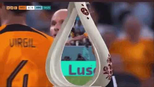 A Soccer Player Wearing A Number 4 Jersey Stands Next To A Trophy GIF